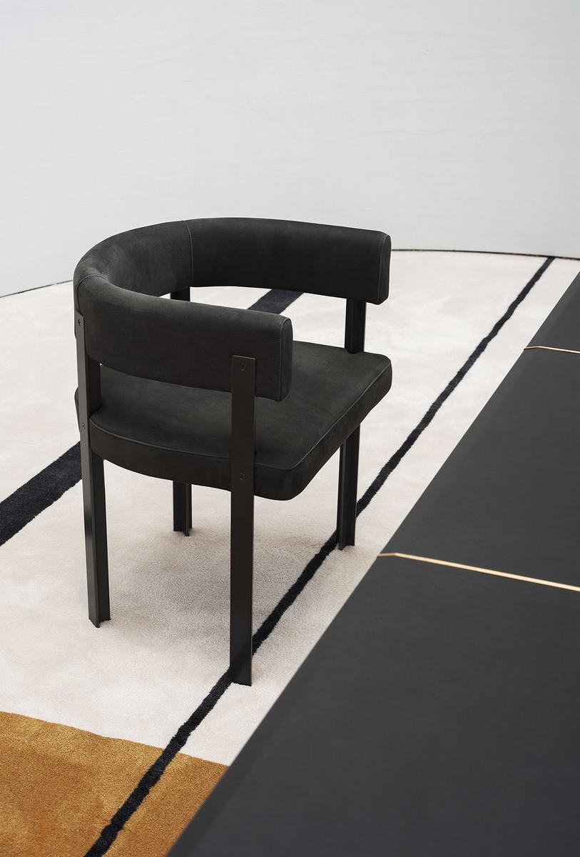 T-CHAIR Upholstered leather chair with armrests