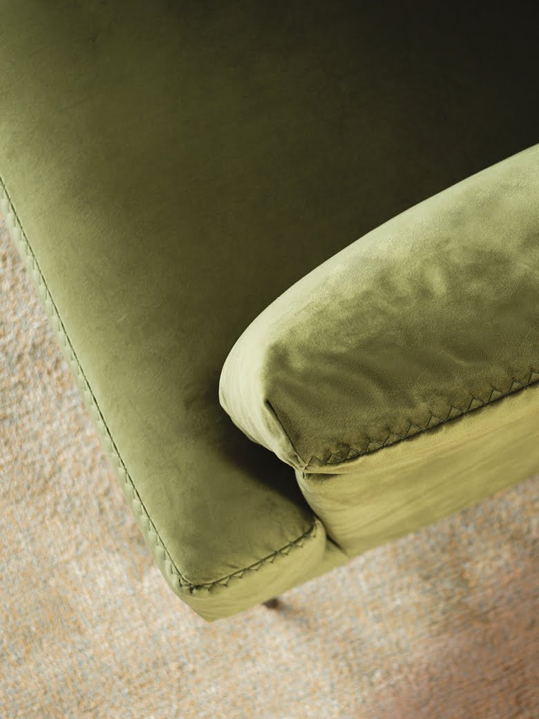 FLEUR Elegant Fleur chair with stylish pin-shaped legs and sophisticated stitches, ideal for both snug homes and professional spaces, offering comfort in compact form with option for leather or removable fabric.